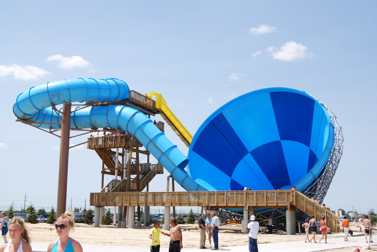Large blue bowl-shaped water slide at a water park