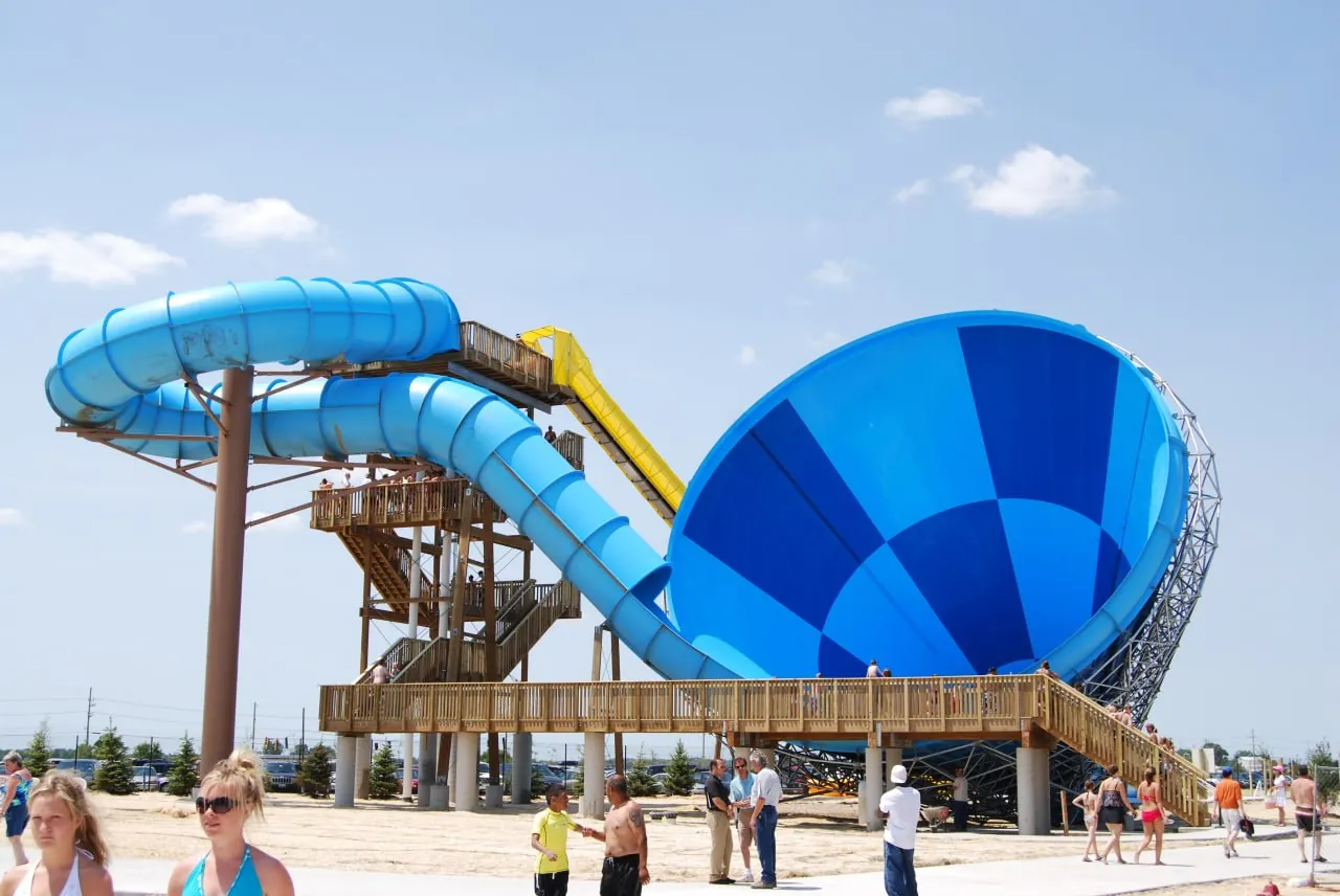 Large blue bowl-shaped water slide at a water park