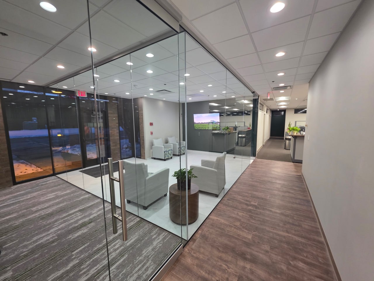 Modern office reception with glass partition and exterior view